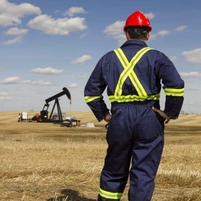 Oil Worker in a Field about accuflow - worker in oilfield